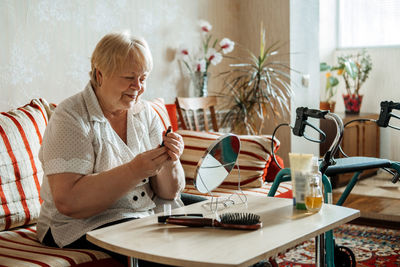 Woman sitting on table at home