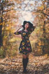 Full length of woman standing by tree