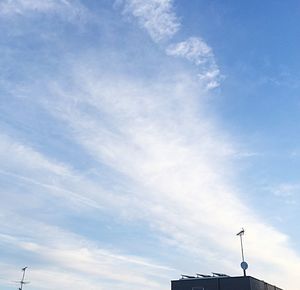 Low angle view of communications tower against sky