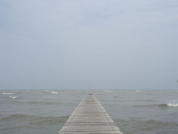 Pier over sea against clear sky