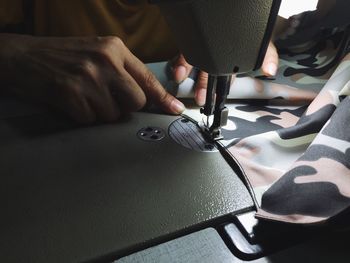 Close up of the tailor working on table