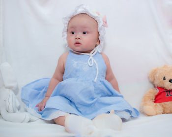 Portrait of cute baby girl sleeping on bed at home