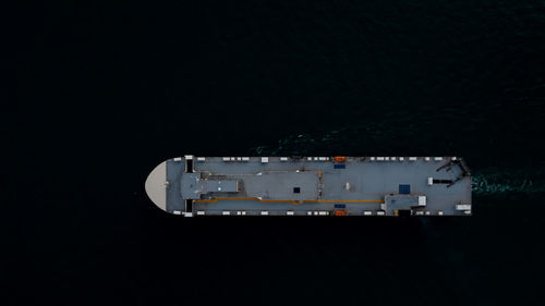 Roro ship sailing in the dark sea aerial top view transportation international concept