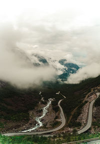 Aerial view of mountain road against cloudy sky