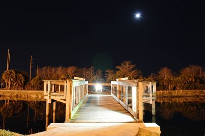 Illuminated scene of wooden bridge at night