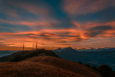 Scenic view of mountains against orange sky