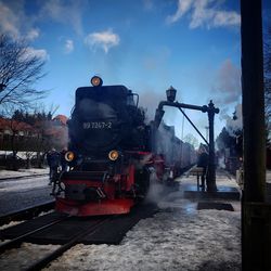 Train on railroad track against sky