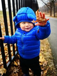 Portrait of smiling boy in park during winter