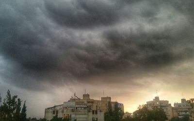 Low angle view of storm clouds over city