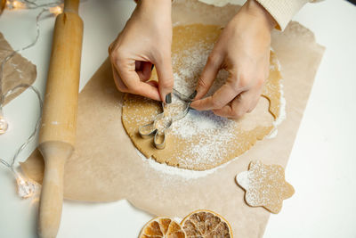 Making christmas gingerbread cookies from dough, holding a mold with your hands