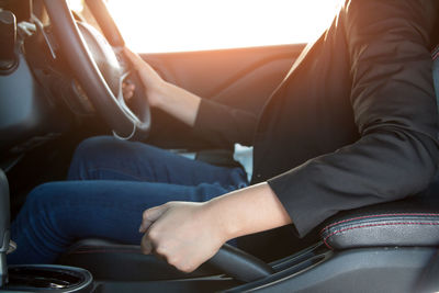 Close-up of woman driving car