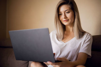 Young woman using laptop at home