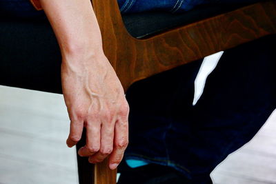 Low section of man sitting on chair