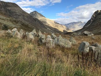 Scenic view of field and mountains against sky