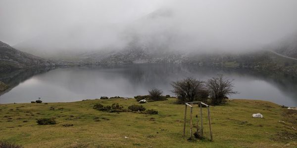 Scenic view of landscape against sky during foggy weather