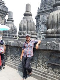 Full length portrait of young man at temple