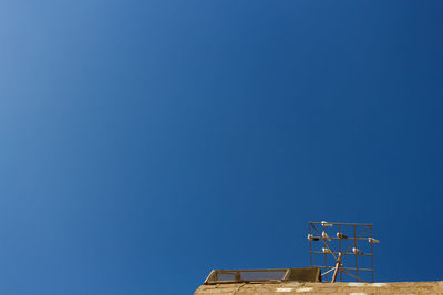 Low angle view of building against clear blue sky