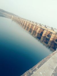 Tilt image of dam on sea against sky