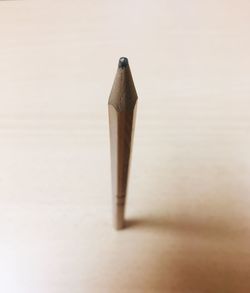 Close-up of pencils on table against white background