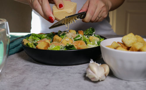 Cropped hand of person preparing food