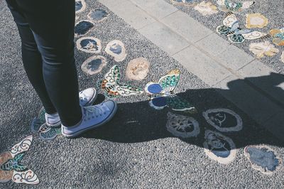 Low section of woman standing on tiled floor