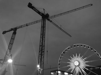 Low angle view of illuminated ferris wheel against sky