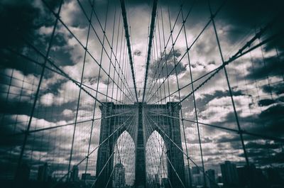 Brooklyn bridge against cloudy sky