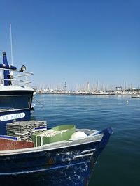 View of harbor against clear blue sky