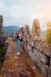 Full length of woman standing in front of building