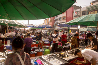 People at market stall in city