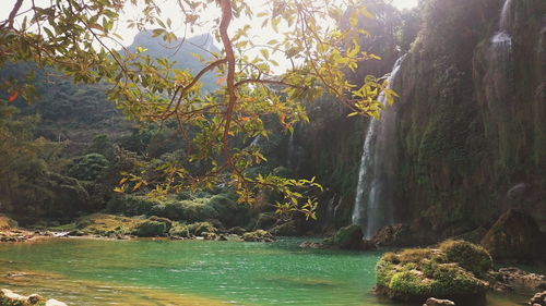 Scenic view of waterfall against sky