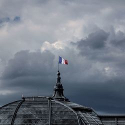 Low angle view of french flag against cloudy sky