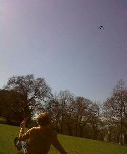 People walking on grassy field