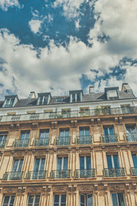 Low angle view of building against cloudy sky