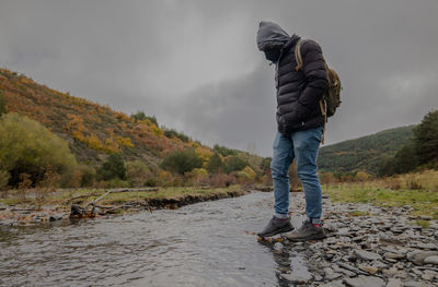 Portrait of adult man walking along river in autumn, in tejera negra, cantalojas, guadalajara, spain