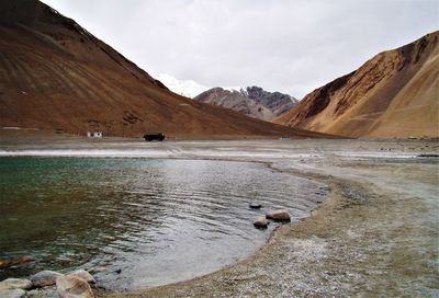 View of birds on mountain against sky