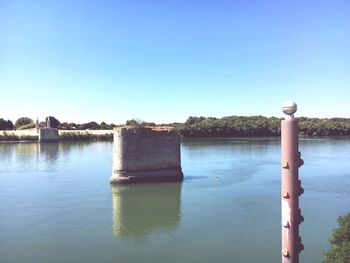 Scenic view of lake against clear blue sky