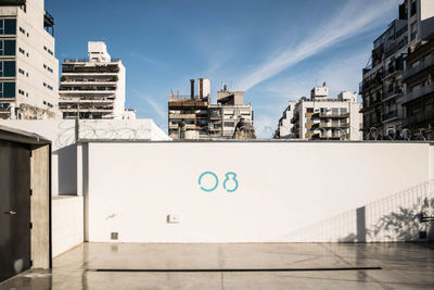 Buildings in city against blue sky