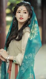 Portrait of smiling young woman sitting at home