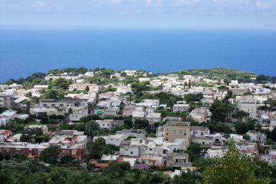 High angle view of townscape by sea against sky