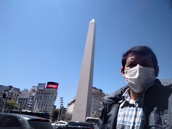 Portrait of man against blue sky