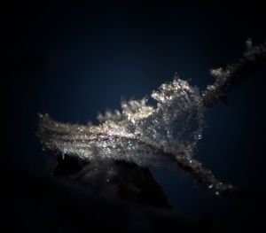 Close-up of frozen water against sky at night