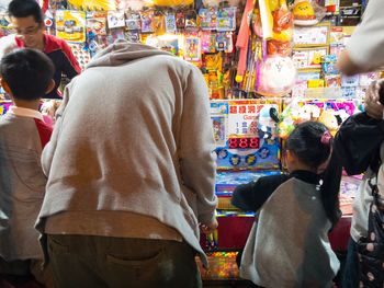 Rear view of people in market