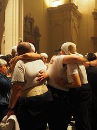 Rear view of people standing in temple