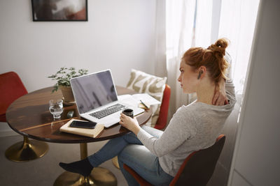 Woman holding her neck