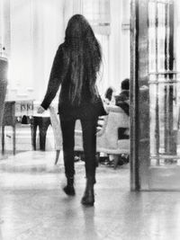 Rear view of people standing in corridor
