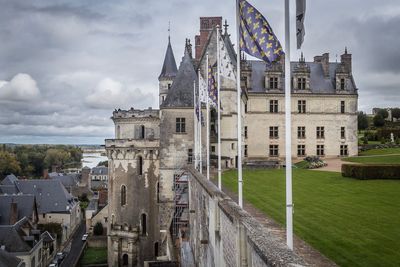 Low angle view of flag in city against sky