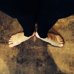 Low section of woman standing on tiled floor