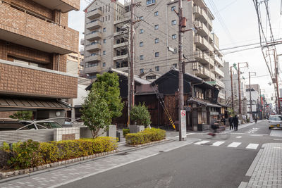 Road by buildings in city