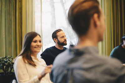 Selective focus of businessman sitting with colleagues in board room